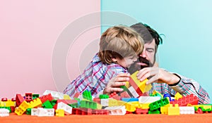 Father and son create constructions. Bearded man and son play together. Surefire ways to bond with your son. Father son photo