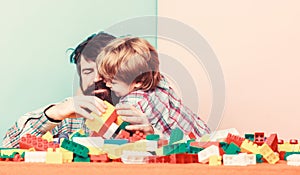 Father and son create constructions. Bearded man and son play together. Surefire ways to bond with your son. Father son