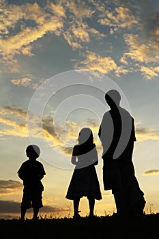 Father, son and daughter looking up