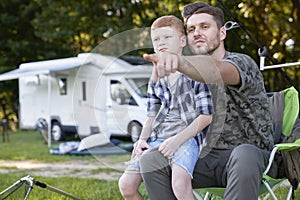 Father and son do fishing on camper trip