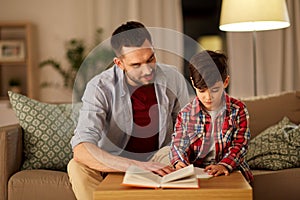 Father and son doing homework together