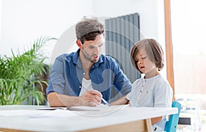 Father and son doing homework together