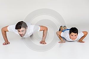 father and son doing push ups together