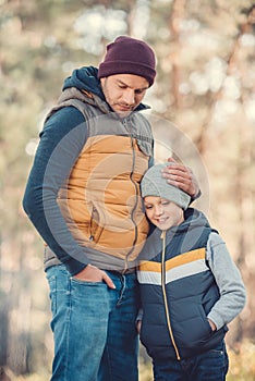 father and son embracing while standing together