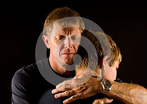 Father and son in emotional hug photo