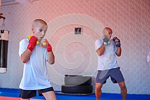 Father and son are engaged in the gym