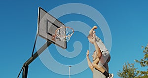 Father and son enjoy a playing basketball.