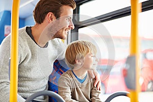 Father And Son Enjoying Bus Journey Together