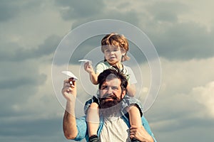 Father and son. Father giving son ride on back in park. Father and son in the park. Freedom to Dream - Joyful Boy