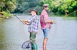 Father and son fishing. Fisherman fishing equipment. Fisherman grandpa and mature man friends. Fisherman family. Hobby