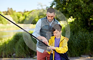 Father and son fishing on river