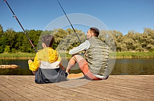 father and son fishing on river