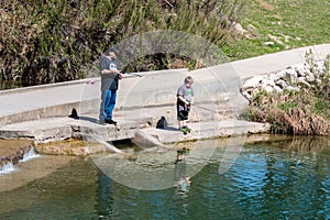 Father and Son Fishing in the River