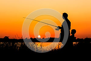 Father and son fishing in the river