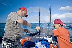 Father and son fishing at sea