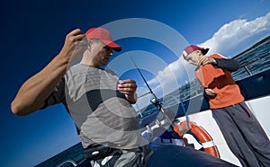 Father and son fishing at sea