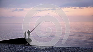 Father and son fishing at a sea shore