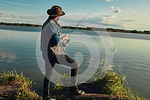 Father and son fishing together on sunny day