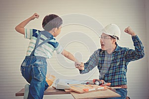 Father Son fist bump for success concept in construction industry concept in vintage tone