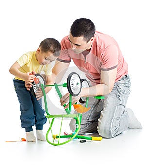 Father and son fixing repairing bicycle wheel