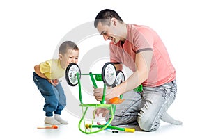 Father and son fixing repairing bicycle wheel photo