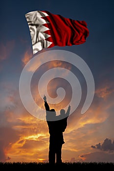 Father with son and the flag of Bahrain