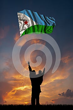 Father with son and the flag of Djibouti