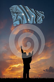 Father with son and the flag of Micronesia