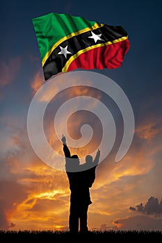 Father with son and the flag of Saint Kitts and Nevis