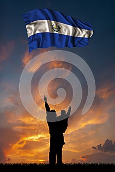 Father with son and the flag of Salvador