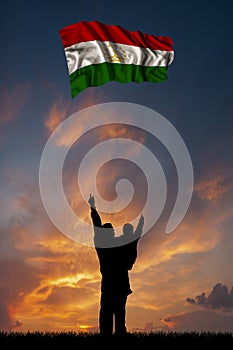 Father with son and the flag of Tajikistan