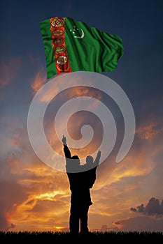 Father with son and the flag of Turkmenistan