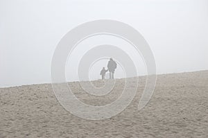 Father and son in the fog photo