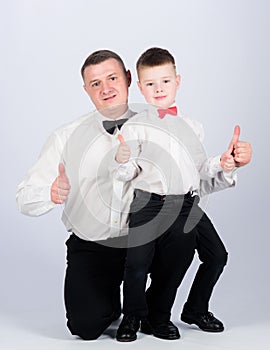 Father and son formal clothes outfit. Grow up gentleman. Dad and boy white shirts with bow ties. Gentleman upbringing