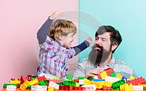 Father son game. Father and son create constructions. Bearded man and son play together. Surefire ways to bond with your photo
