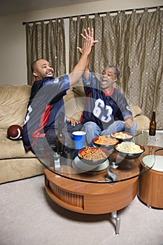 Father and son giving high five.