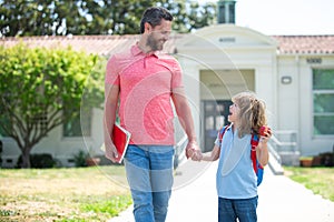 Father and son go to school, education and learning. School, family, education and outdoor concept.