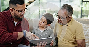 Father, son and grandparent as family with tablet on sofa in living room of home together for visit. Technology