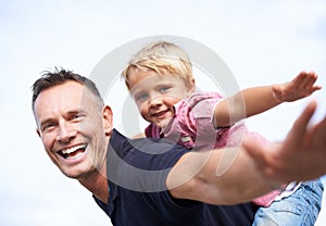 Father, son and happy with airplane game by outdoor, freedom and fun with love bonding in city. Man, child or playing