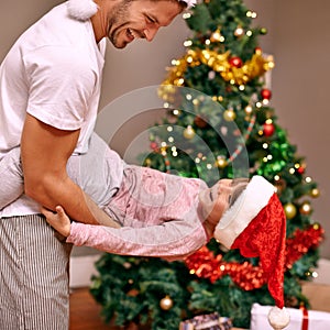 Father, son and happy with bonding on christmas for celebration, playing and love in the morning with santa hats. Family