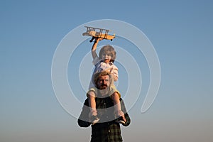 Father and son happy family. Father carrying his son on shoulders.