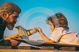 Father and son - happy moment. Father and boy playing with toy plane. Dream to be a pilot.