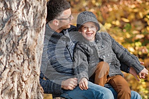 Father and son happy playing together outdoors in the park