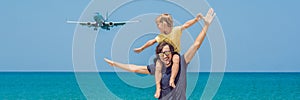 Father and son have fun on the beach watching the landing planes. Traveling on an airplane with children concept BANNER, long form