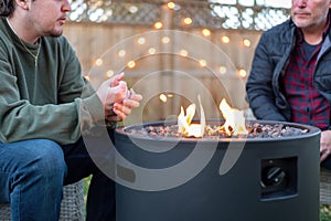 Father and son having a fireside chat in the backyard