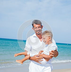 Father and son having fun on the beach