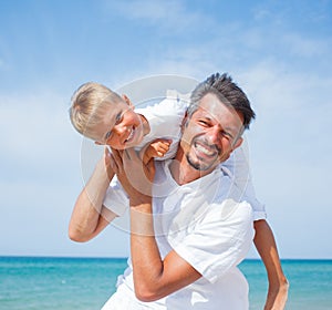 Father and son having fun on the beach