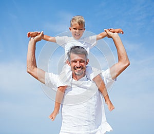 Father and son having fun on the beach