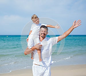 Father and son having fun on the beach