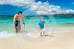 Father and son having fun on a beach